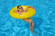 © SuperCoolPhotography - Real adorable girl relaxing in swimming pool