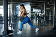 © nazarovsergey - Fit brunette performing lunges on cable crossover at gym