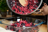 Fototapeta  - Mrożone owoce w garnku. Przygotowanie deseru.