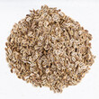 pile of dried dill seeds close up on gray