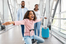 Happy Black Family Traveling With Kid, Standing In Airport
