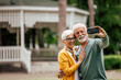 © bnenin - Mature husband, taking a picture of him and his wife.