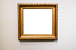 old wide golden picture frame on gray wall