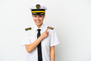 Wall Mural - Airplane blonde woman pilot isolated on white background pointing to the side to present a product