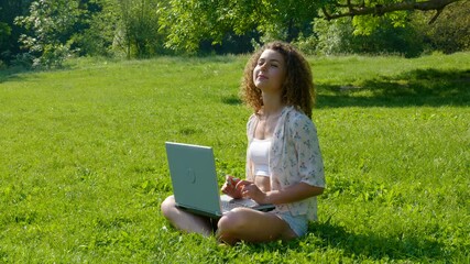 Beautiful girl student working on laptop in the park
