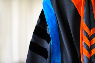 PhD graduate in black graduatio gown University degree