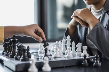 Two business women competitors playing chess board game, business competition concept, business plan to be the number one company, competitor analysis and problem solving. For always good results.