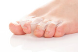 Fototapeta Sawanna - Silicone finger separator. Orthopedic toe corrector on white background.