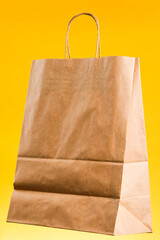 Wall Mural - Empty brown paper shopping bag with Handles.