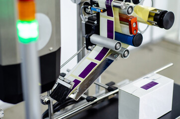 close-up of automatic sticker labelling machine
