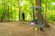 Disc golf is a flying disc sport in which players throw a disc at a target; it is played using rules similar to golf, this player is “putting” on a course in Toronto.