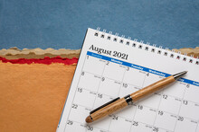August 2021 - Spiral Desktop Calendar Against Colorful Abstract Paper Landscape, Time And Business Concept