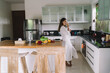 © BullRun - Gorgeous young ethnic woman drinking water in modern kitchen