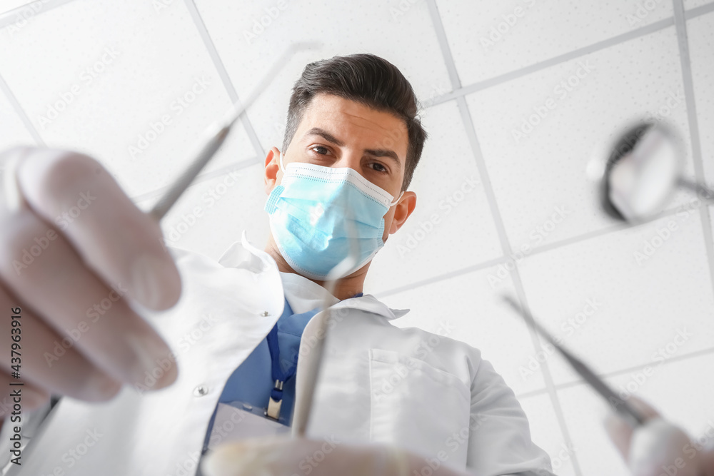 Male dentist working with client, closeup