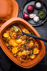 Wall Mural - Goulash with potatoes and sauerkraut. Beef and vegetable stew in clay pot