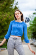 © Andrey_Arkusha - Young beautiful girl in a blue blouse and gray jeans
