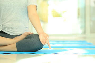 Group of meditation of students and teacher practicing relaxation of mind at yoga studio. Tranquility by calm position is the way of zen and buddhism.