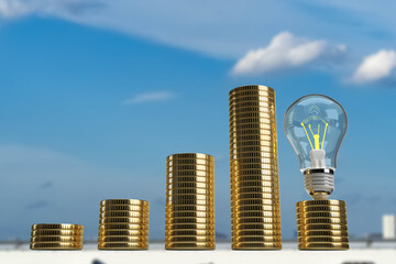 Blue sky capital city urban coin golden lightbulb lamp fluorescent power electrical glass technology digital wealth rich money banknote currency saving budget investment financial economic.3D Render