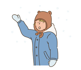 A boy in a cute bear hat is trying to catch snow. hand drawn style vector design illustrations. 