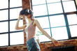 © racool_studio - A blonde woman looks at virtual life wearing VR in the office