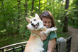 © MrAndruwa - A beautiful girl holds her fluffy, kind, cheerful corgi dog.