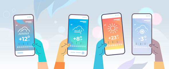 human hands holding smartphones with daily temperature mobile app weather forecasting and meteorology