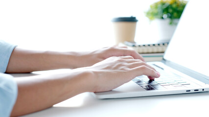 Wall Mural - close up of man hand typing laptop computer while working at home office, student college online stu