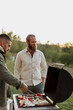 © Johnér - Male friends preparing food on barbecue
