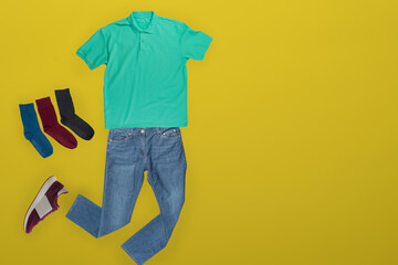 flat lay, men's fashion. jeans, t-shirt, socks on a wooden background. casual clothes top view