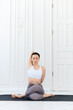 © etonastenka - Young woman practicing yoga in a light background. Healthy lifestyle concept