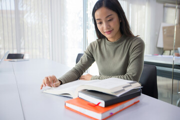 Asian women Students Smile and reading book  at library