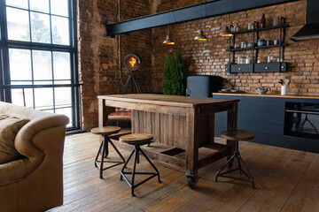 side view on a wooden table and spacious industrial loft kitchen with vintage decor and black cabine