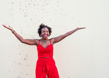 Happy African American Woman Standing Under Confetti During Celebration