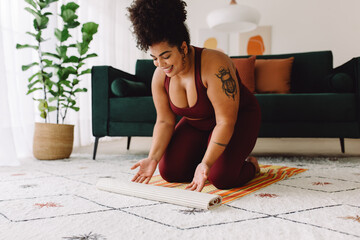 Wall Mural - Fitness woman placing yoga mat on floor