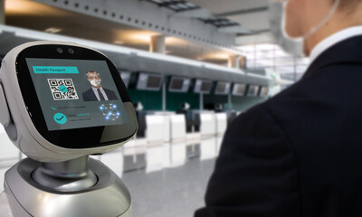 Smart hospitality industry concept, airport or hotel using robot to  scan and personal data check with customer who got covid-19 vaccinate by using face recognition detection technology