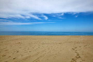 White clouds, blue sea and yellow sandy beach