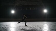Skater Training At The Indoor Ice Rink. Figure Skating At The Stadium. The Woman Performs The Elements Of Figure Skating, Layback Spin.