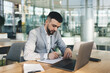 © BullRun - Young male entrepreneur in smart suit working in modern office