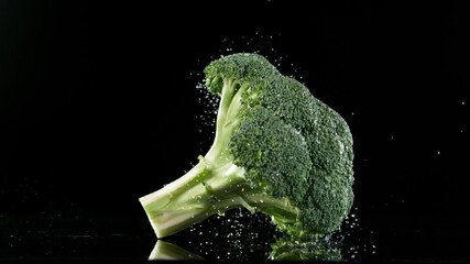 Fototapete - Super slow motion of falling broccoli on water surface, 1000 fps.
