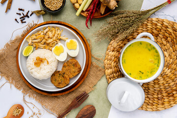 Wall Mural - Nasi Soto Ayam or Soto Medan is  Traditional chicken soup with rice from Medan, North Sumatra. 

Soto is a traditional Indonesian soup mainly composed of broth, meat, fried patties and vegetables.