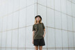 © ADDICTIVE STOCK - Millennial woman on concrete wall in town