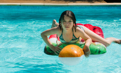 cute little girl lounging on her floating mattress