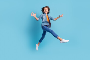 Poster - Full size profile side photo of young preteen boy happy positive smile go walk jump isolated over blue color background