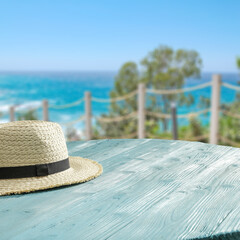 Poster - Wooden desk of free space and summer hat 