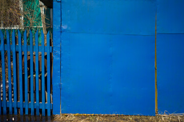 garage and fence painted in blue