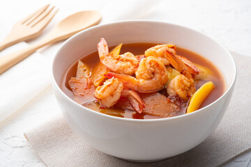 Wall Mural - Sour Soup with Papaya and Shrimp in white bowl.Thai food