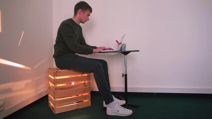 Poster - A man uses a laptop in the office. He looks at the screen. Focus on work, freelancer. High-speed internet to your home office.