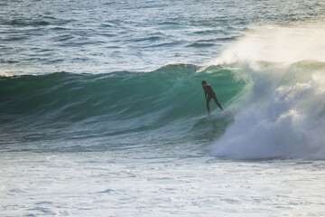 Surfer on Blue Ocean Wave . Surf spot in Ericeira Portugal.