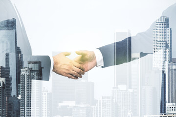 Handshake of two businessmen on modern cityscape background, deal and trading concept. Multiexposure