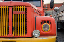 Old Orange And Yellow Truck With Round Headlights